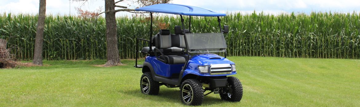 Blue reconditioned golf cart parked on grass